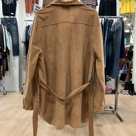 Brown shirt on a hanger in a clothing store