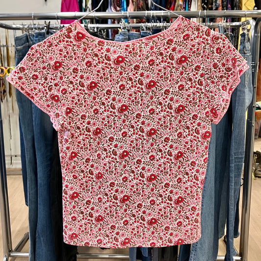 Red floral-patterned shirt on a rack with jeans