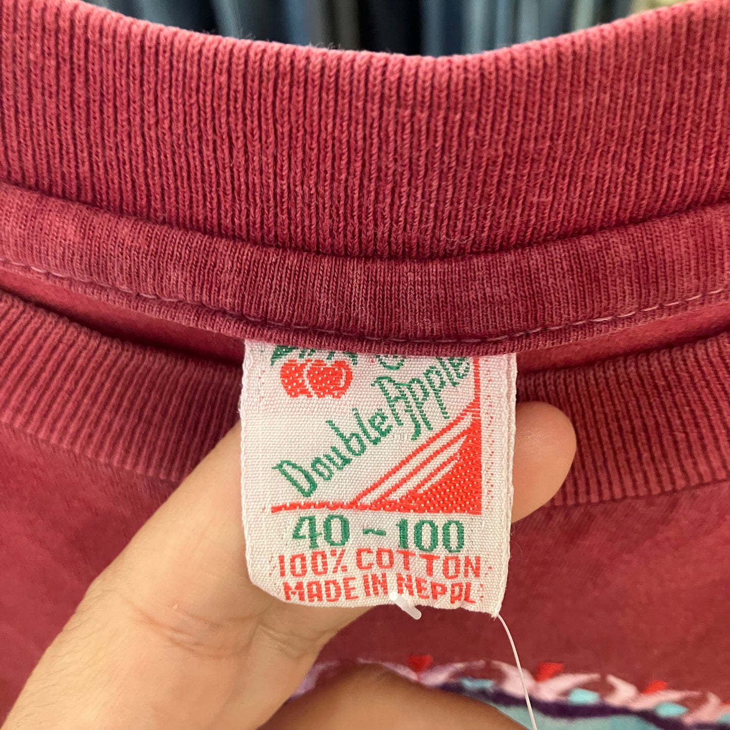 double apple burgundy tee with blue om meditation graphic