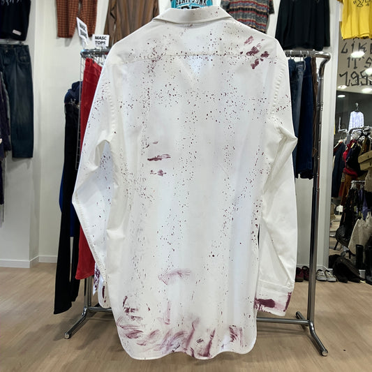 White shirt with red splashes on a mannequin in a clothing store