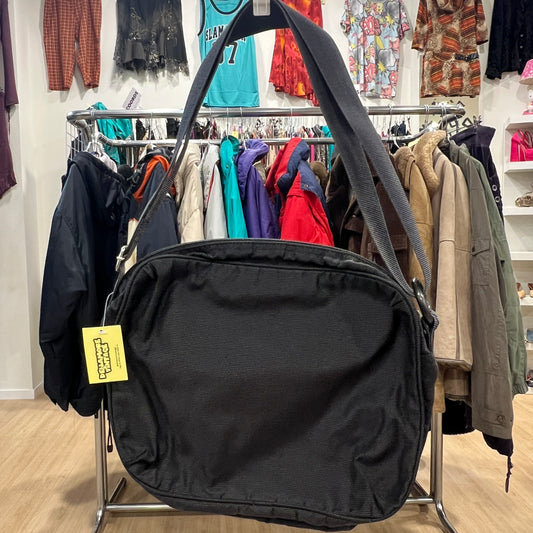 Black bag with a yellow tag in a clothing store