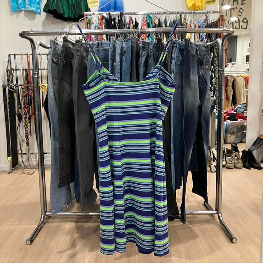 Striped dress hanging on a rack with jeans in a store setting