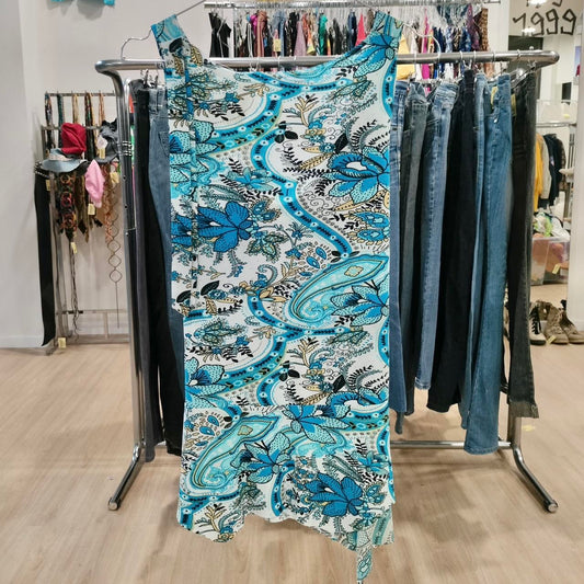 Blue floral dress on a rack with jeans in a store setting