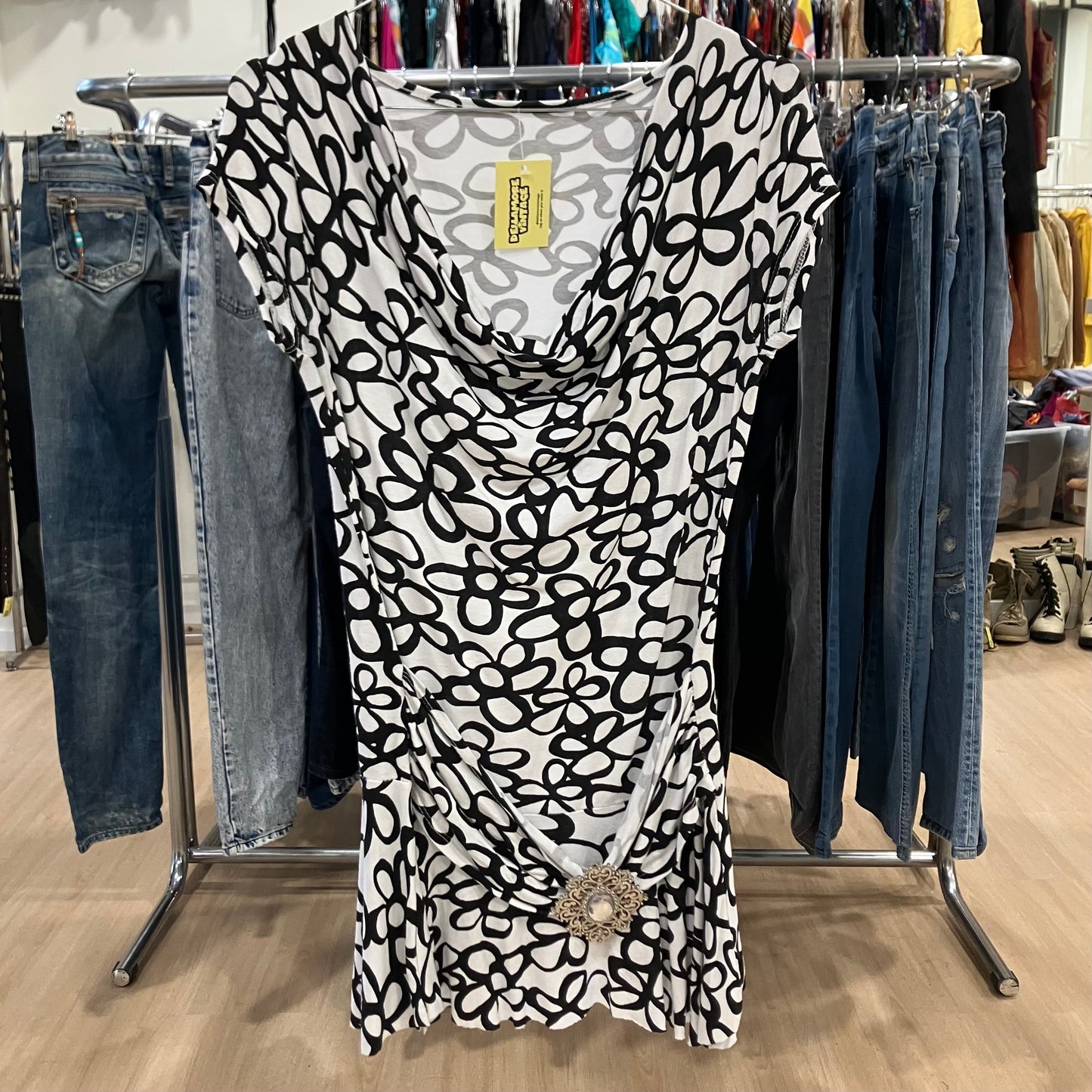 white black floral minidress with draped neck and maxi jewel buckle