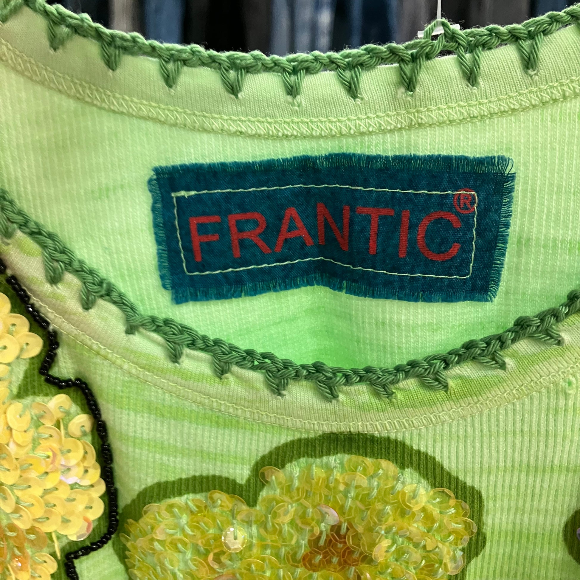 Close-up of a green fabric with a 'Frantic' label