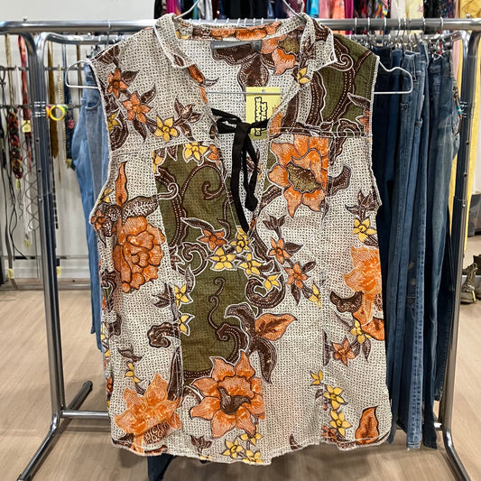 Floral patterned blouse on a rack with a visible tag in a store setting