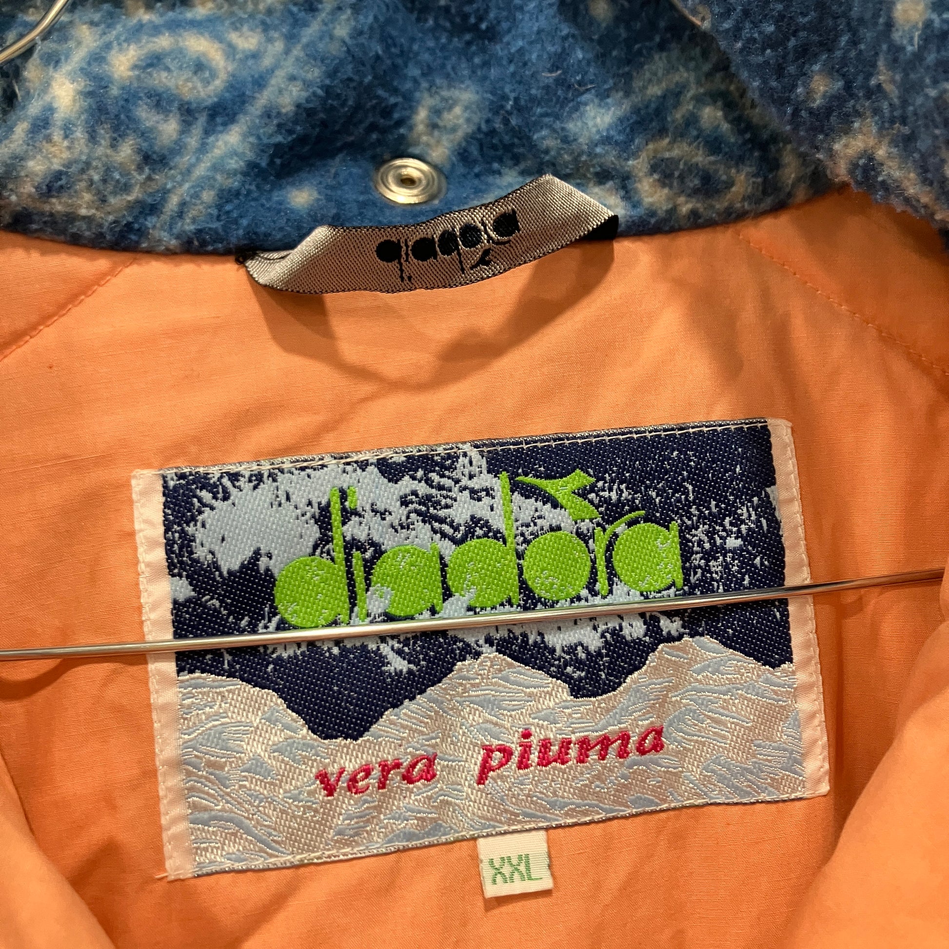 Close-up of a label on a piece of clothing with 'vera piuma' branding