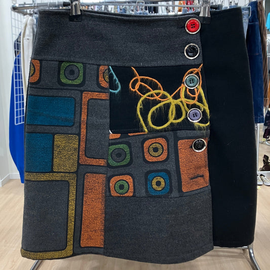 Skirt with abstract pattern and colorful buttons on a rack