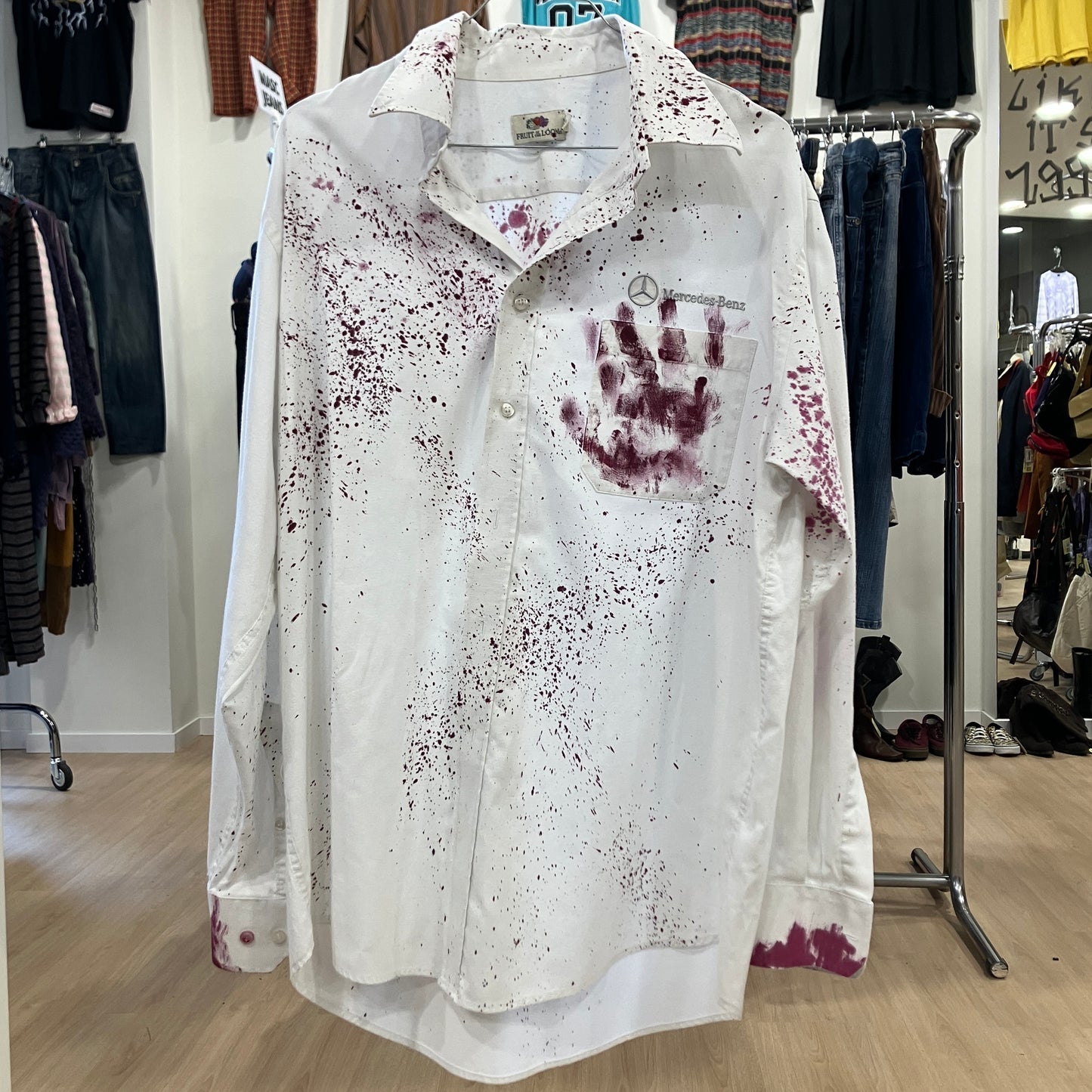 White shirt with bloodstains and a handprint in a clothing store