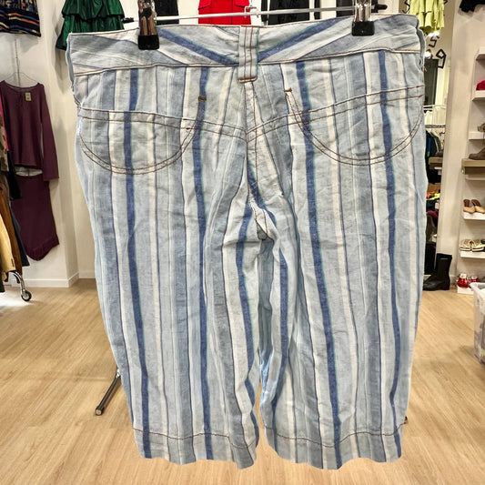 Striped pants hanging on a rack in a store setting