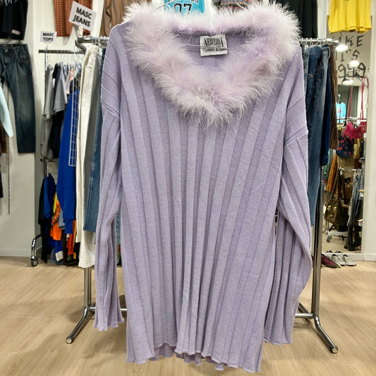 Purple ribbed sweater with fluffy hood on a hanger in a store setting