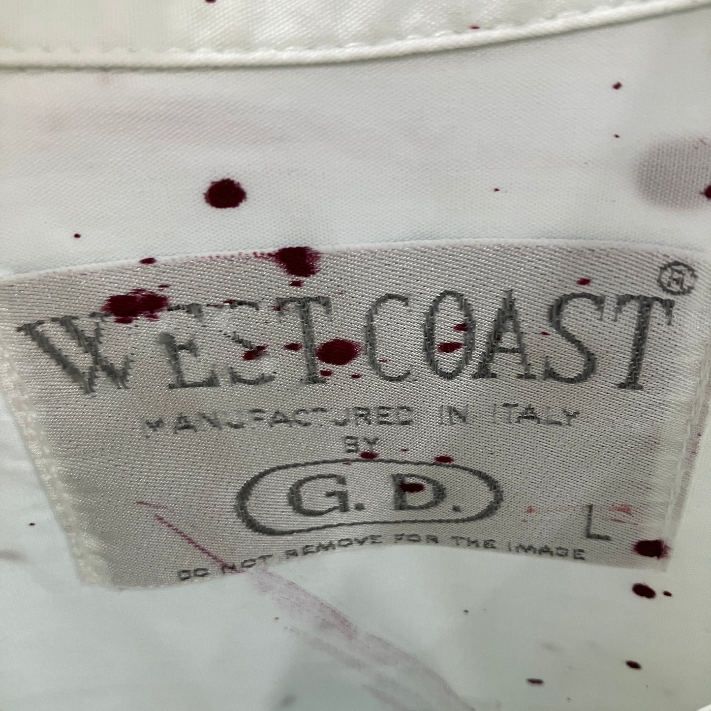 West Coast label on a garment with visible bloodstains