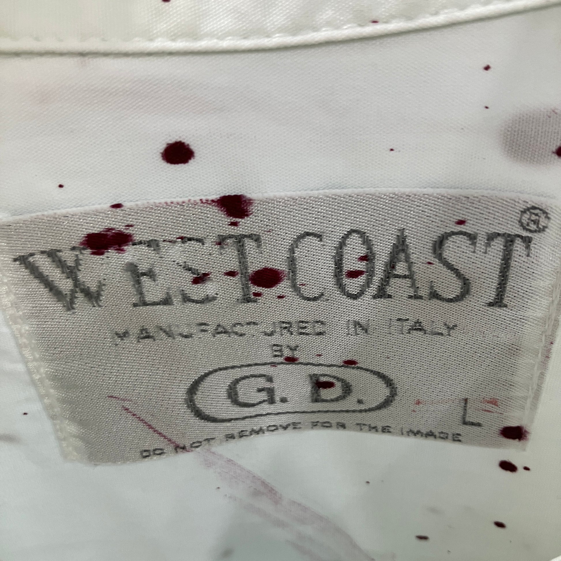 West Coast label on a garment with visible bloodstains