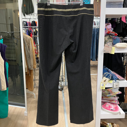 Black pants hanging on a rack in a store setting