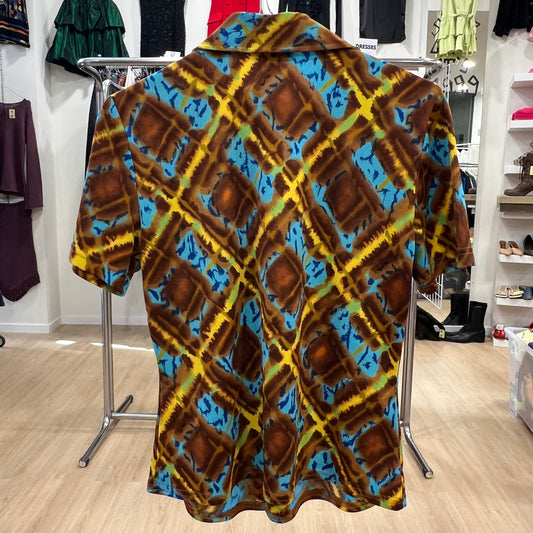 Colorful patterned shirt on a hanger in a store setting
