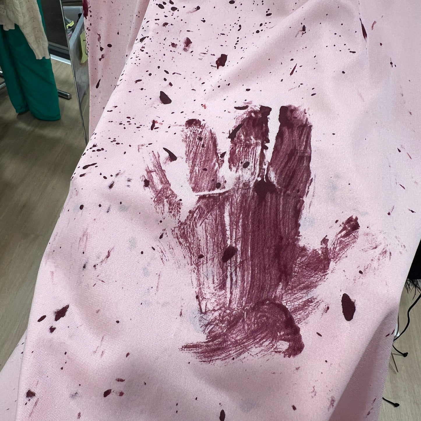 Handprint made with red paint on a white fabric surface