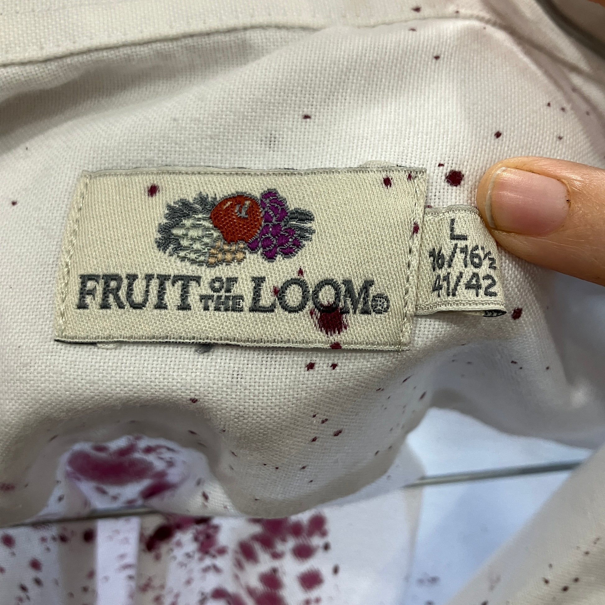 Close-up of a 'Fruit of the Loom' label on a piece of clothing with visible text and logo