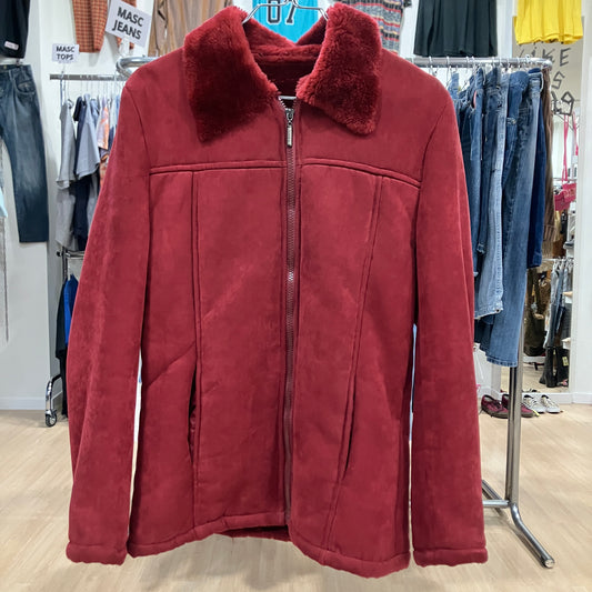 Red jacket with fur collar on a rack in a clothing store