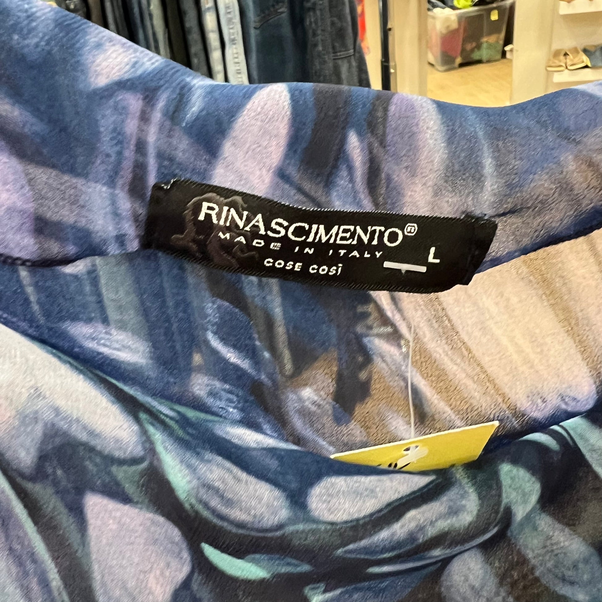 Close-up of a Rinascimento label on a patterned fabric background