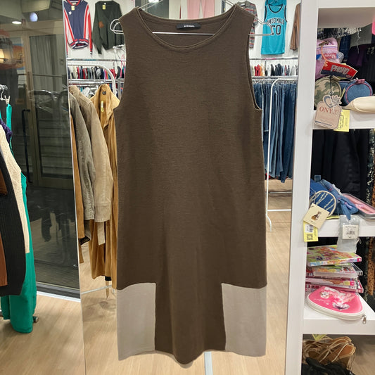Brown sleeveless dress hanging in a store with clothing racks and shelves in the background