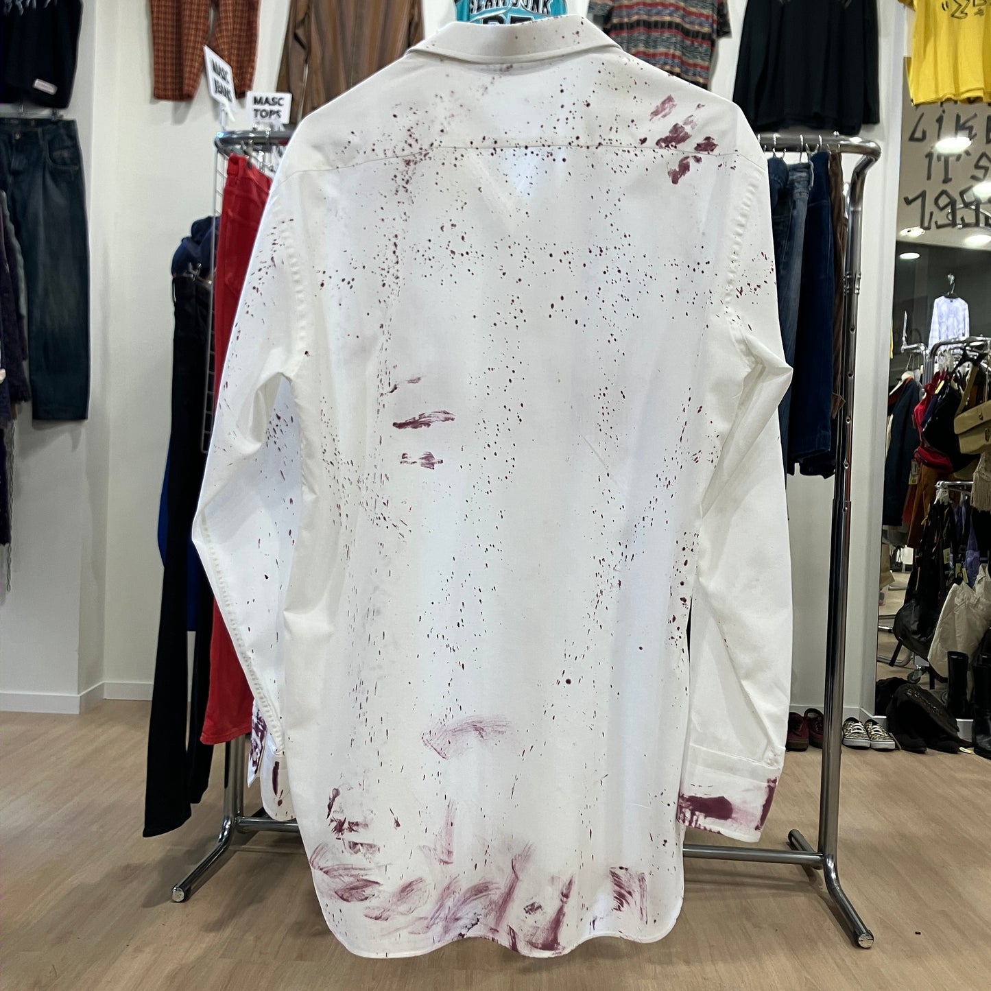 White shirt with red splashes on a mannequin in a clothing store