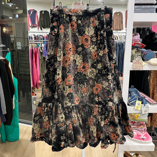 Floral patterned dress on a rack in a store setting