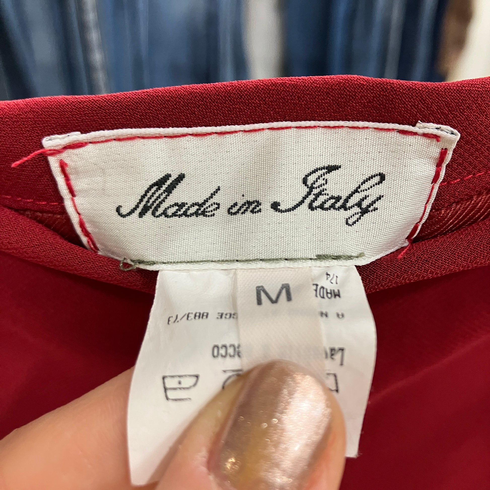 Label on a red garment indicating 'Made in Italy'