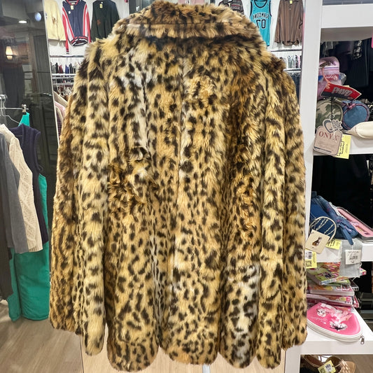 Leopard print coat in a store setting with clothing racks and shelves in the background