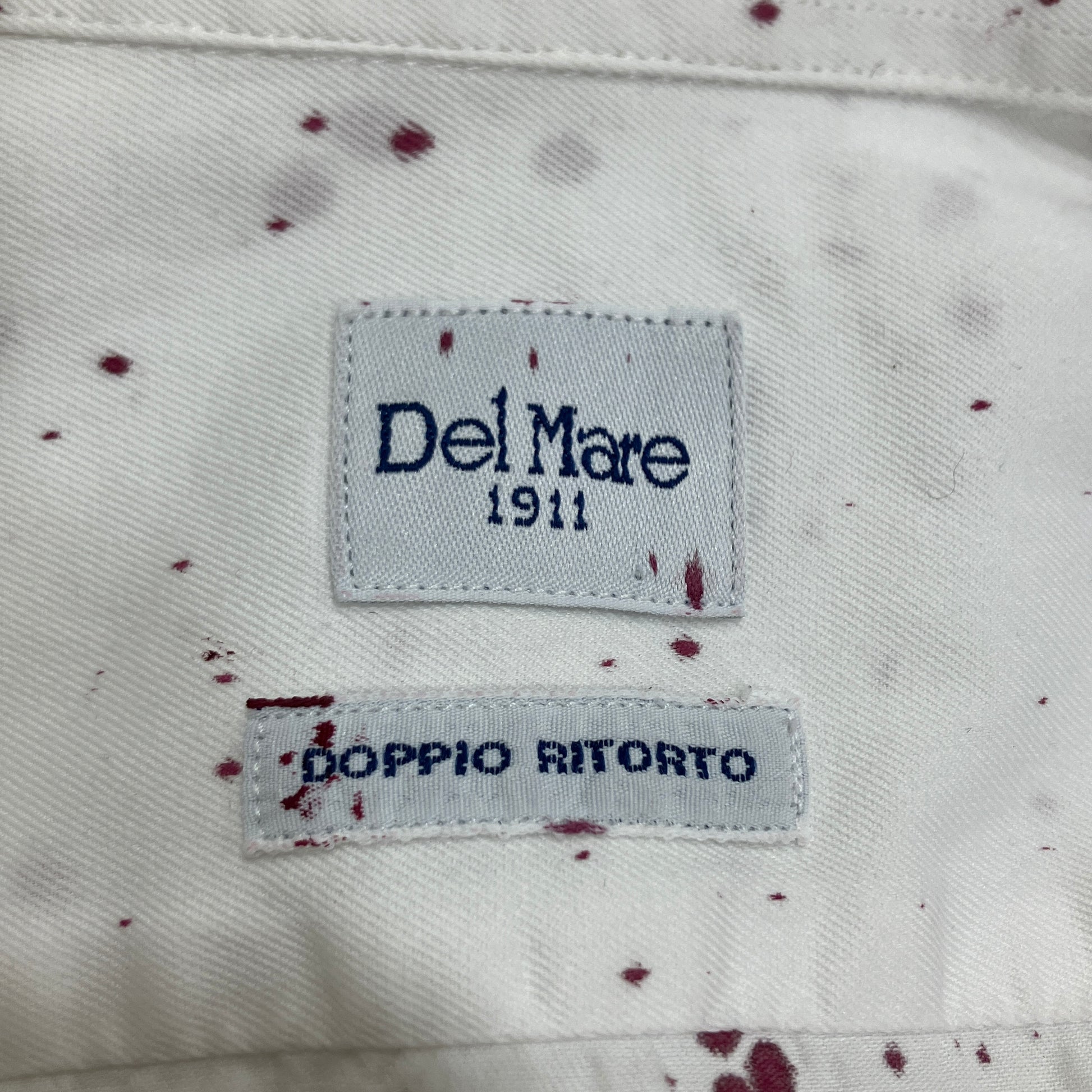 Label on a garment with 'Del Mare 1911' and 'Doppio Ritorto' text