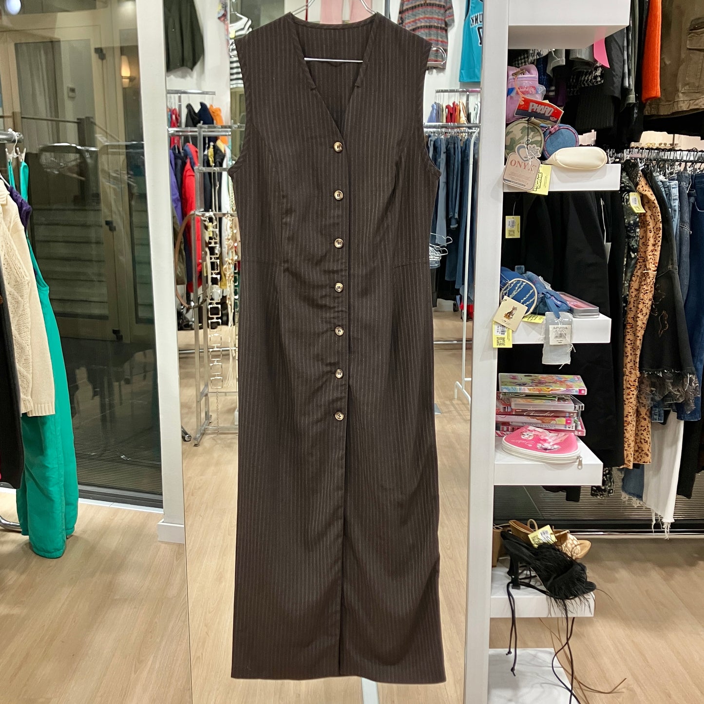 Brown pinstripe dress on a rack in a clothing store