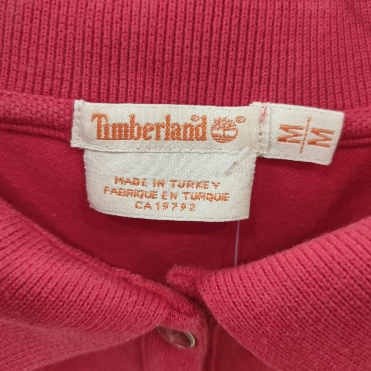 Timberland label on a pink fabric background