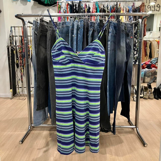 Striped dress hanging on a rack with jeans in a store setting