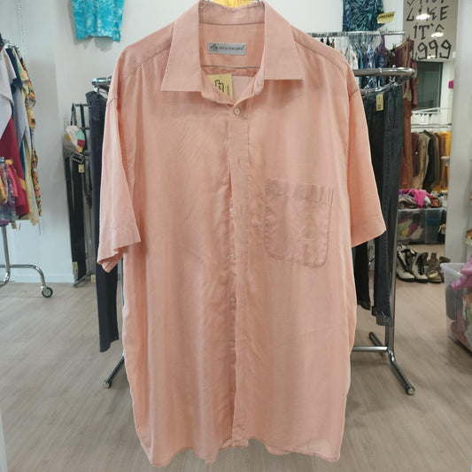 Pink shirt on a hanger in a store setting