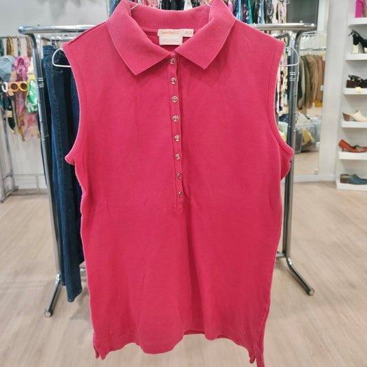 Pink sleeveless polo shirt on a rack in a store setting