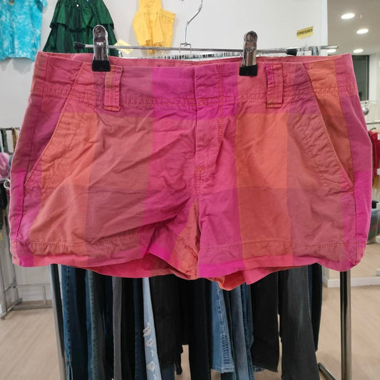 Pink shorts on a rack with a blurred store background
