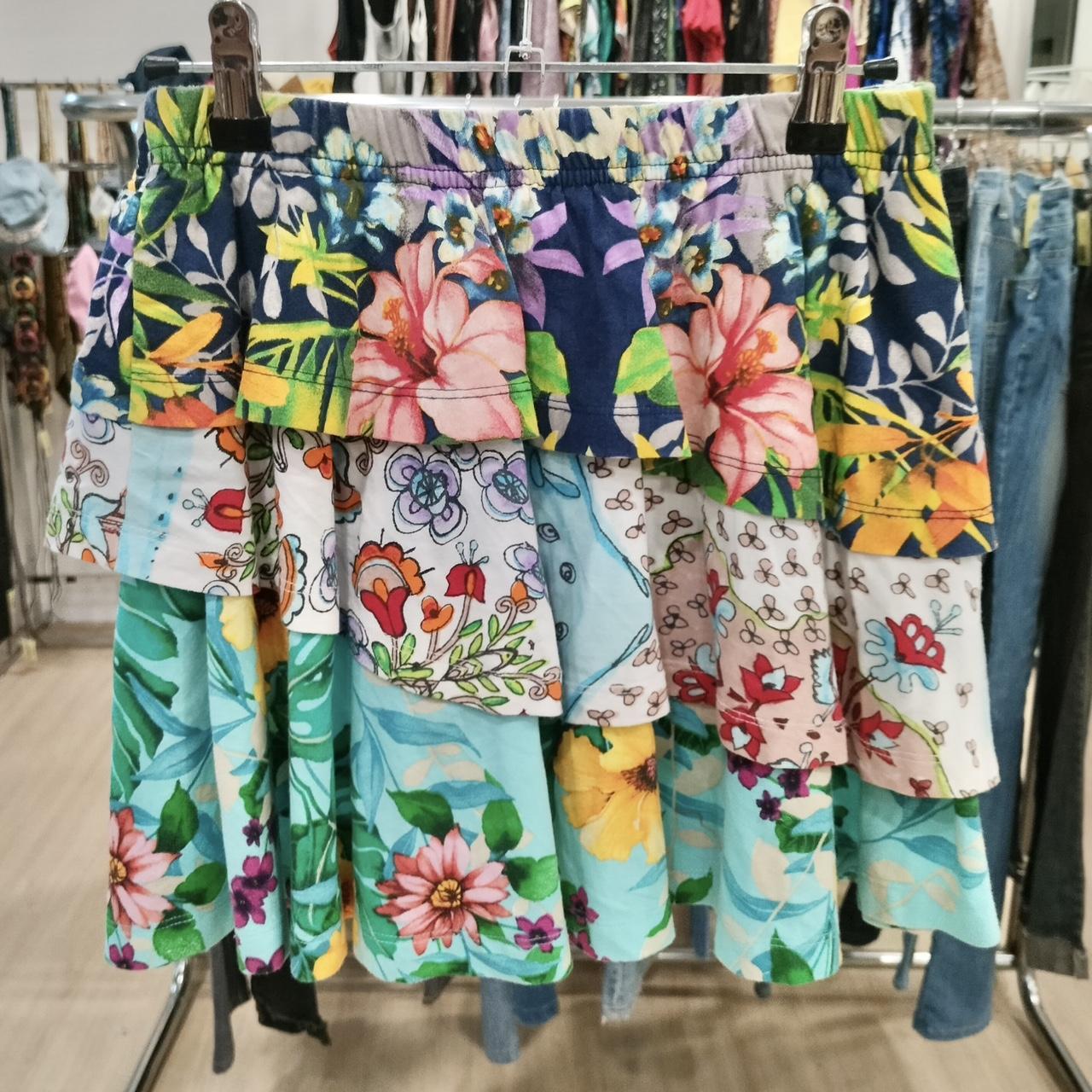 Colorful floral-patterned skirt hanging on a rack