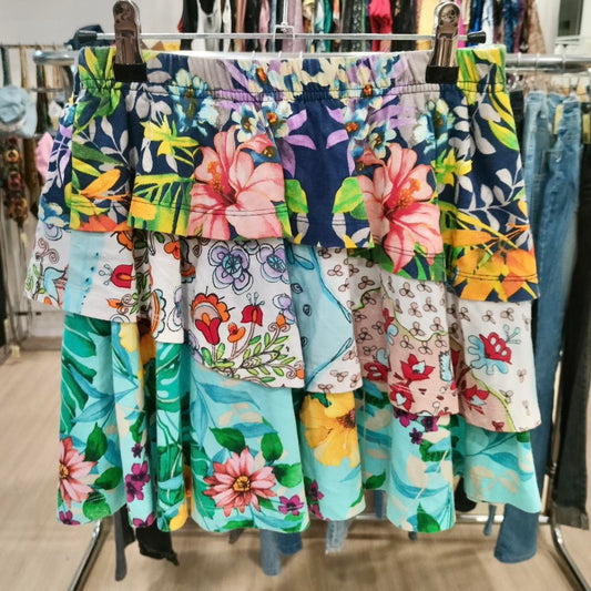 Colorful floral-patterned skirt hanging on a rack