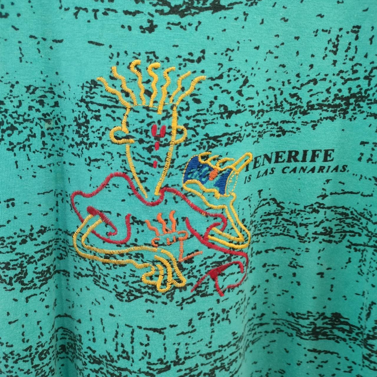 Teal t-shirt with colorful graphic design and 'Tenerife is Las Canarias' text