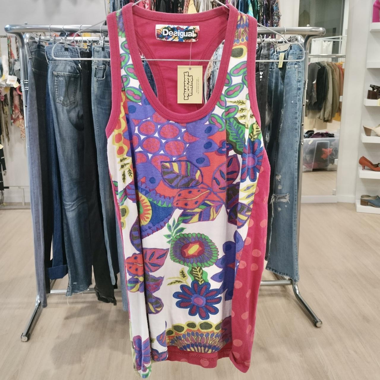 Colorful tank top with floral pattern on a clothing rack in a store