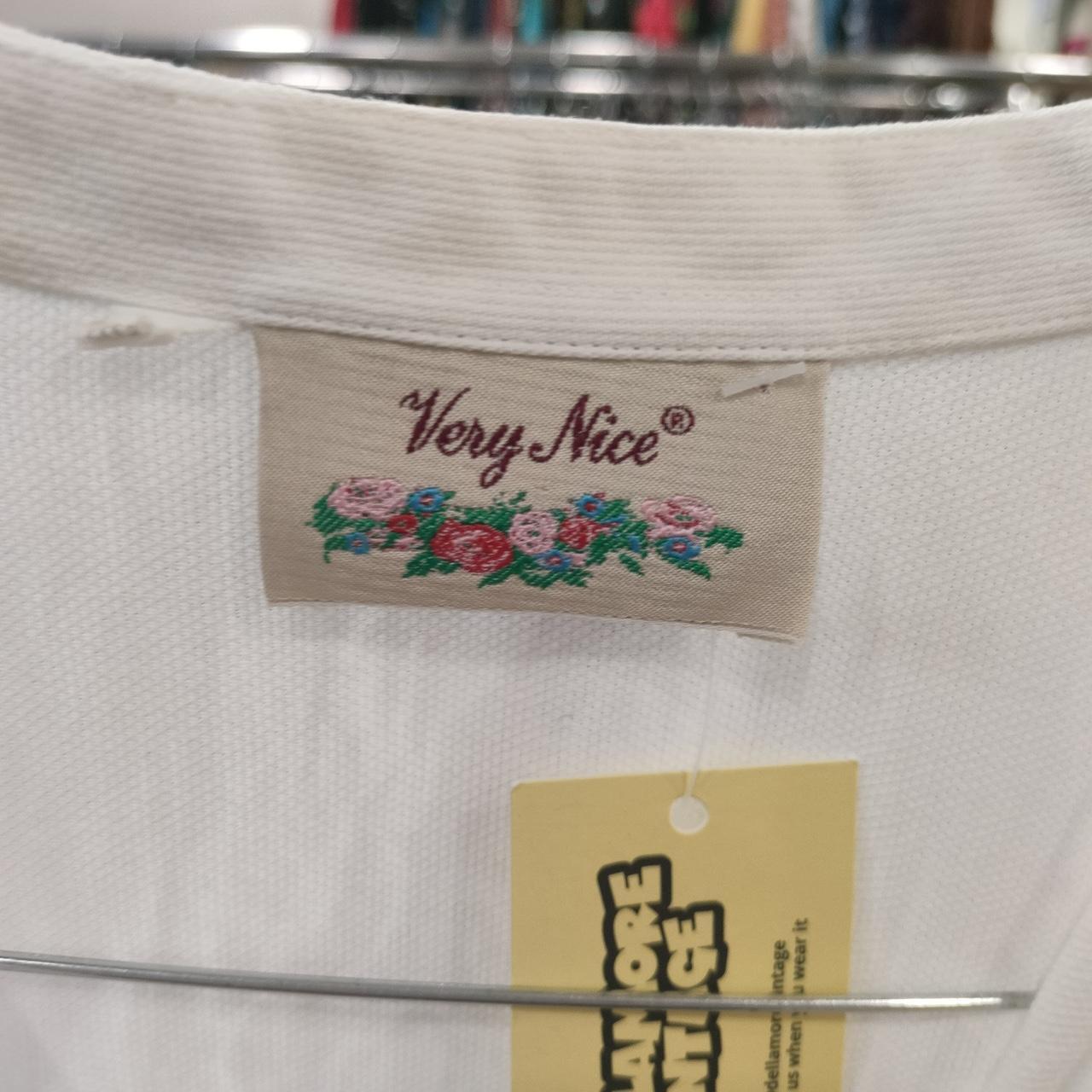 Very nice white embroidered button-down shirt with a sailing embroidery