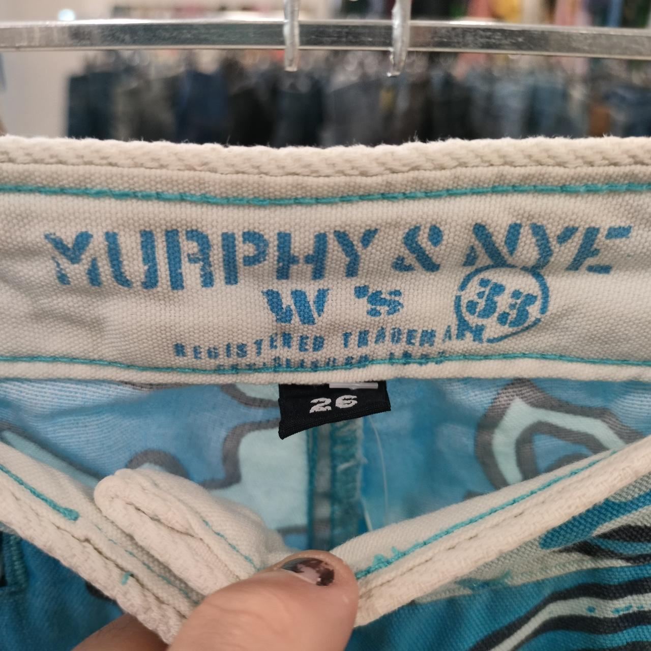 Close-up of a denim jacket with 'Murphy & Nye' branding and size tag