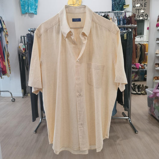 Beige shirt on a hanger in a store setting